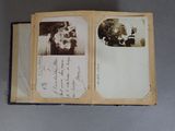 an old photo of a man and a woman sitting in a chair