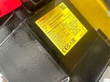 a close up of a machine that has a yellow label on it