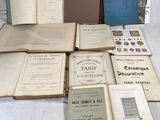 several old books are sitting on a table in front of a wall