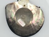 an image of a black shell with a white tag on it