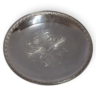 an image of a silver tray with a flower design on it