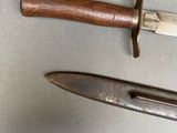 two knives that are laying next to each other on a table