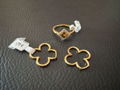 two gold rings and a ring with a flower on it