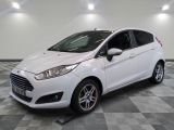 the white ford fiesta is parked in a room with a checkered floor