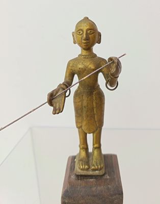 a statue of a woman holding a sword on a glass table