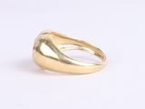 a close up of a gold ring on a white surface