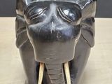 statue of an elephant with tusks on a wooden table