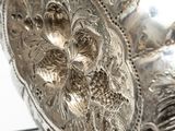 a silver plate with a flower design on it