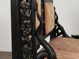 a chair that is sitting in a room with a mirror on the wall