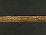 an image of a piece of gold metal on a black surface