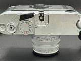 a silver camera that is on a black table