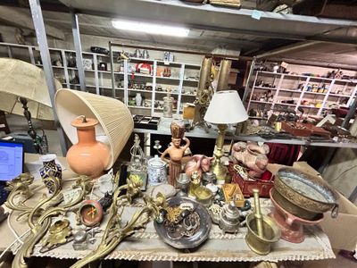 a lot of antiques on a table in a room