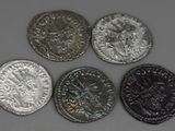 four different types of silver and silver coins sitting on a table