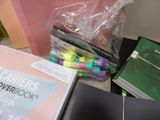 a pile of school supplies sitting on the floor