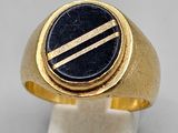 a close up of a gold ring with a black stone on it