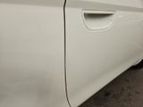 the side of a white car with a black stripe on it