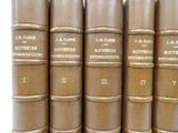 several books are lined up in a row on a shelf