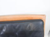 a cat that is sitting on a couch next to a chair