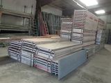 a large pile of wood in a warehouse with a lot of pallets