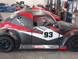 a red and black car parked in a garage
