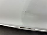 a close up of a white car with scratches on the hood