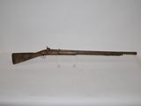 an old rifle with a wooden barrel on a white surface