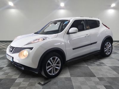 a picture of a white nissan suv parked in a garage