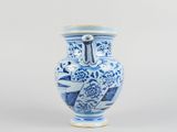 a blue and white vase sitting on a white surface