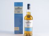 a bottle of the glenlivet single malt whisky next to a blue box