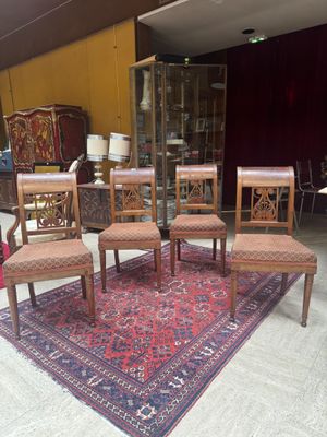 six chairs and a table in a room with a rug on the floor