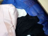 a cardboard box filled with clothes and a blanket