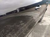 a close up of a car door handle on the side of the road