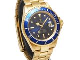 rolex submarine watch with blue dial and gold bracelet