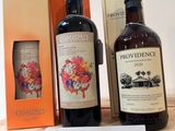 three bottles of wine are on a table with a price tag
