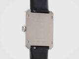 a close up of a watch on a black leather strap