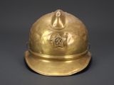 an antique brass fireman ' s helmet with a star on the top