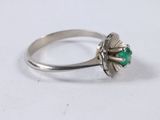 an image of a ring with a green stone in the center