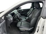 the interior of a white car with black leather seats and a steering wheel