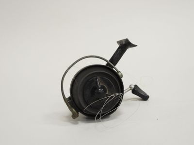 a small black object on a white surface with wires