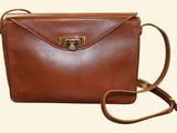 an image of a brown leather purse with a gold clasp