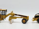two toy construction vehicles that are sitting next to each other