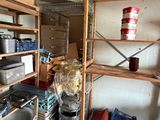 many pots and pans on the shelves in the kitchen