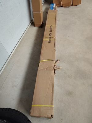 a large cardboard box sitting on the floor next to a pile of boxes