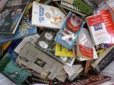 a pile of books sitting on top of a bed
