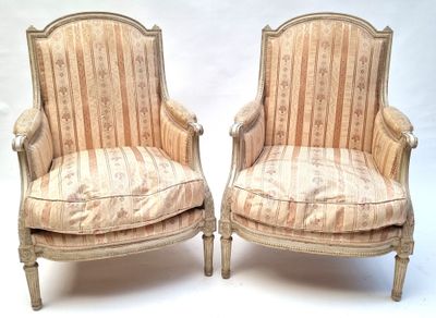 pair of upholstered chairs with striped upholstered cushions