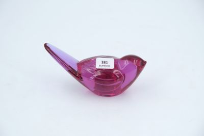 a small purple glass bird with a tag on it