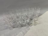 many empty wine glasses lined up on a table