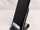 a phone that is sitting on a stand on a table