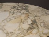 a marble table with a black base and a white top