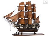 a model of a sailing ship on a wooden stand